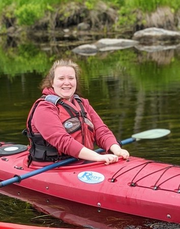 Young woman in a red kayak.